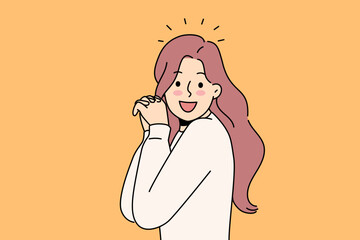 Laughing woman raises hands and looks at screen, enjoying meeting you or glad to receive good news. Laughing girl with long hair experiences delight and positive emotions after achieving goals