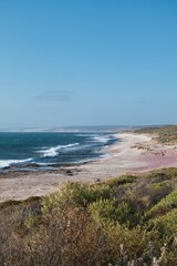 The wild and beautiful coastline of the Kalbarri National Park, Western Australia. Colorful bushland next to the deep blue ocean. Western Australia seaside landscape. Australian travel destination. 