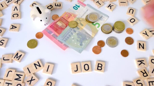 paper euro banknotes, piggy bank, bills on table among euro coins, word Mini job with wood blocks, part-time with low wage concept, marginal employment, help for pension fund, health insurance