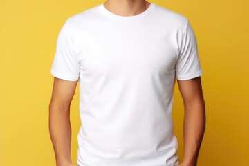 Young man wearing bella canvas white shirt mockup at yellow background