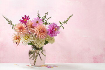 Bouquet of beautiful dahlias on old background in grunge style, abstract floral arrangement, spring or autumn background with place for text, minimal holiday concept, low key still life, 