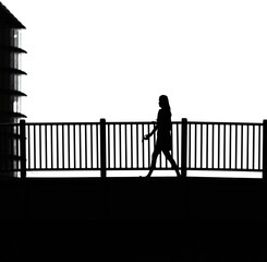 silhouette of a person walking on a bridge