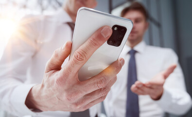 man using smartphone pressing finger, reading social media internet, typing text or shopping online.