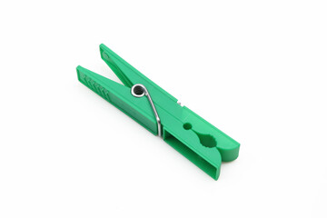 Plastic green clothespin isolated on white background