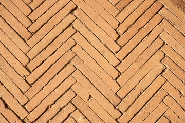 The floor is made of small clay tiles as a background.