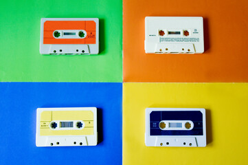 four old cassette tapes of different colors