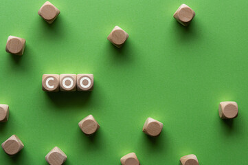 There is wood cube with the word COO. It is an abbreviation for Chief Operating Officer as...