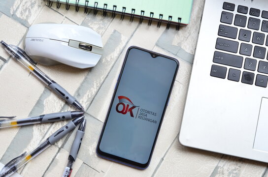 Bekasi, Indonesia - June 2021: OJK or otoritas jasa keuangan on smartphone, popular government money institution in Indonesia 