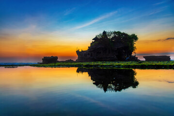 Silhouette of Tanah Lot temple in golden sunset it the most attraction and travel destination of...