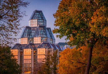 View of the National Gallery of Canada during autumn with fall foliage, Ottawa, Ontario, Canada. Photo taken in Major's Hill Park in November 2021.