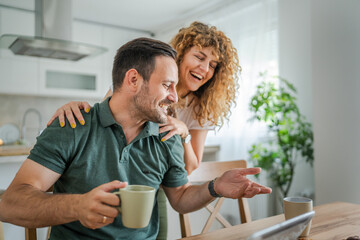 Young couple man and woman enjoy cup of tea or coffee in the morning