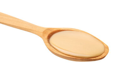 Wooden spoon with tasty peanut butter isolated on white