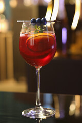 Glass of delicious refreshing sangria on table against blurred background