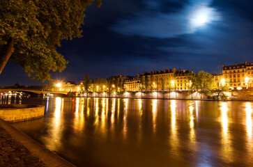 Fototapeta na wymiar River Seine and Pont du Carrousel bridge at night in Paris France.