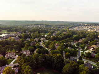 Aerial panoramic view of an upscale subdivision shot during golden hour.