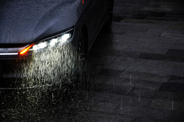Cars driving in the rain with headlights