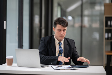 Fototapeta premium Businessman talking to customers online together at the office.