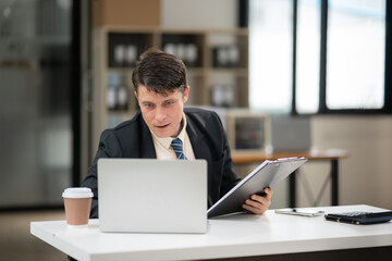 Businessman talking to customers online together at the office.