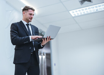 Confident man leads, showcasing leadership, strategic thinking, overseeing operations with laptop