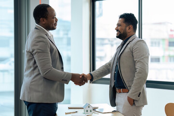 Real Estate agent and customer shaking hands after successful contract