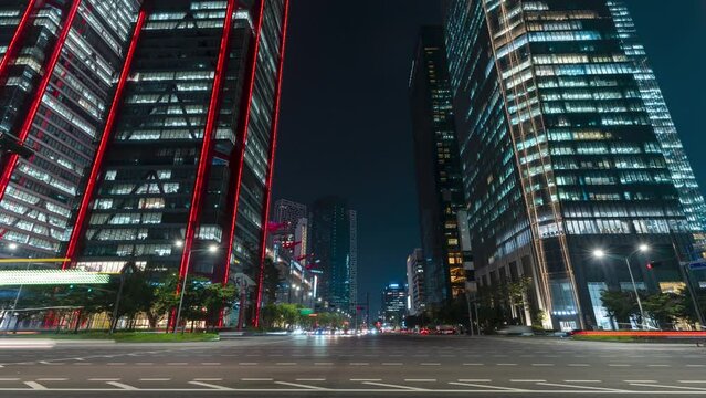 Busy Night Car Traffic Time Lapse on Yeoui-daero in Yeouido Business DIstrict of Seoul Next to Parc.1 Tower and IFC Mall Skyscraper Buildings - Static Wide Shot