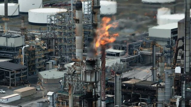 Aerial view of flames in front of a gas refinery - oil production