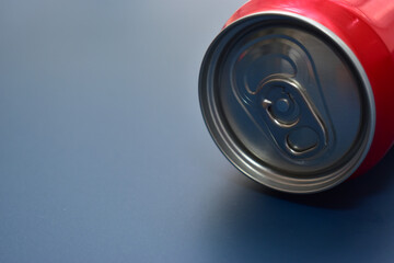 aluminium red cans soft drink put on blue texture background