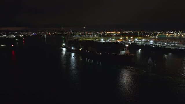 Drone Night Flying Over Water With A Shipping Container Ship Coming Out Of Newport Yarra River. Getting Towed Leaving Port Top Down View Port Melbourne