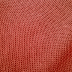 Orange fabric texture background close-up of threads 