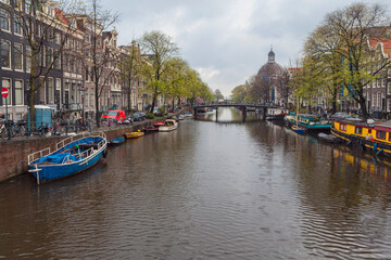 Fototapeta na wymiar Canal and houses of Amsterdam. Amsterdam is the capital and most populous city of the Netherlands.