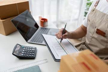 Startup, small business, SME owner check online orders. data logging Business growth, selling products, working with boxes. freelance work at home office online sme business small organization