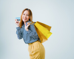 Asian woman carrying colorful shopping bags, young woman sitting and use smartphone for shopping online, Asian beautiful women shopping online