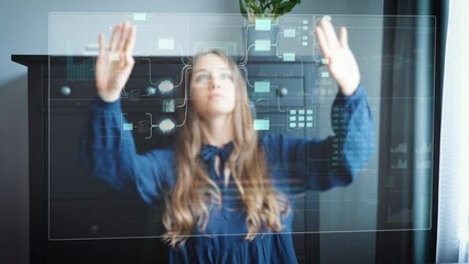 Female works with graphical user interface projection screen in home office. User interface shows interactive charts and graphics