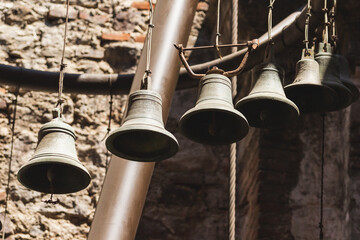 Sunlit Church Bell: Ancient Copper Pieces in Six - obrazy, fototapety, plakaty
