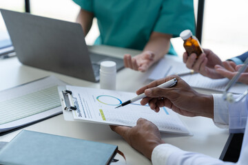 Medical Meeting for teams in the office to discuss, brainstorm and plan research. Medicine, doctors, nurses and laptops record data together showing diversity teamwork or a workshop for data analysis