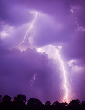 Photo of a dramatic purple sky with intense lightning strikes