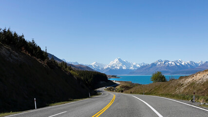 The road trip with mountain landscape view of blue sky background over Aoraki mount cook national park,New zealand