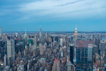 Captivating aerial view of New York City skyline right after the sunset seen from The Edge. The buildings are starting to lit up the lights. Endless rows of buildings. Bustling city. Endless horizon