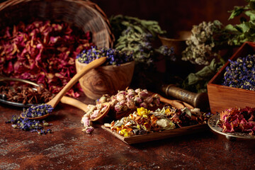  Various dried medicinal plants on a brown background.