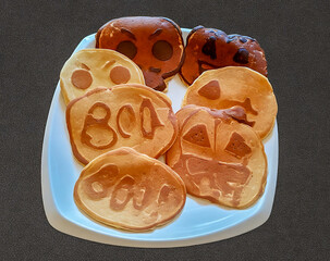 a delicious scary variety of Halloween pancakes on a Plate