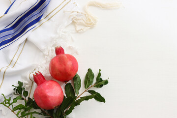 religion image of pomegranate on white prayer talit. Rosh hashanah (jewish New Year holiday),...