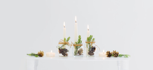home christmas decor with burning candles in whte interior