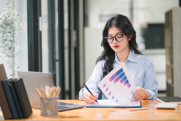 Businesswoman is analyzing financial data,A professional woman accountant is using tablet in her office for accounting and tax-related tasks.