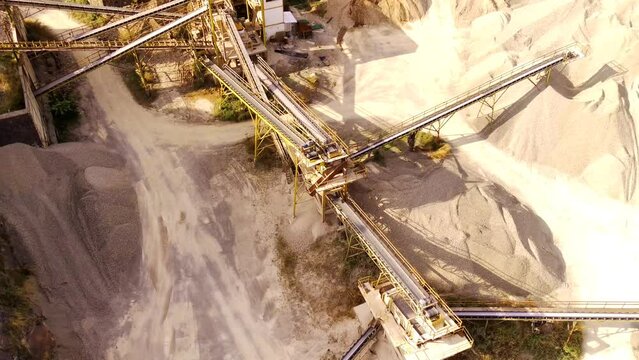 Industrial Extraction and Manufacturing Footage. Aerial video of a gravel pit and conveyor belts for stone distribution. Active mining facility located on Mount Pangradinan. Bandung - Indonesia