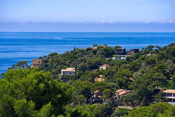 Fototapeta na wymiar Aerial view of Mediterranean Sea seen from viewpoint of village of Giens with sailing boats in the background on a sunny late spring day. Photo taken June 10th, 2023, Giens, Hyères, France.
