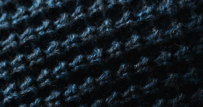 Micro video of close up of blue wooly crochet fabric with copy space
