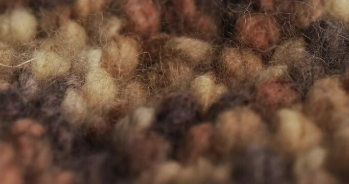 Micro video of close up of brown wooly crochet fabric with copy space
