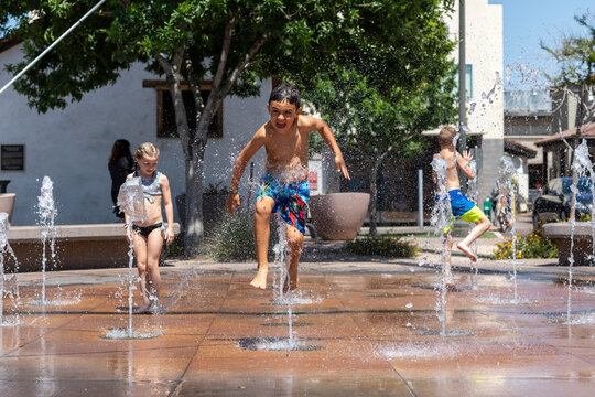 Kids play in water on splashpad