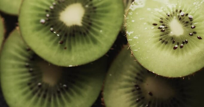 Micro video of close up of slices of kiwi fruit with copy space
