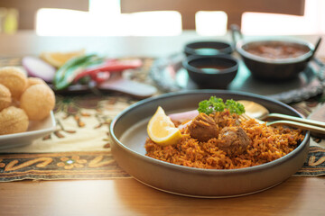 Close up, Biryani popular Indian food, made with spices, vegetables, rice, and meat, ready to eat on the table, selective focus